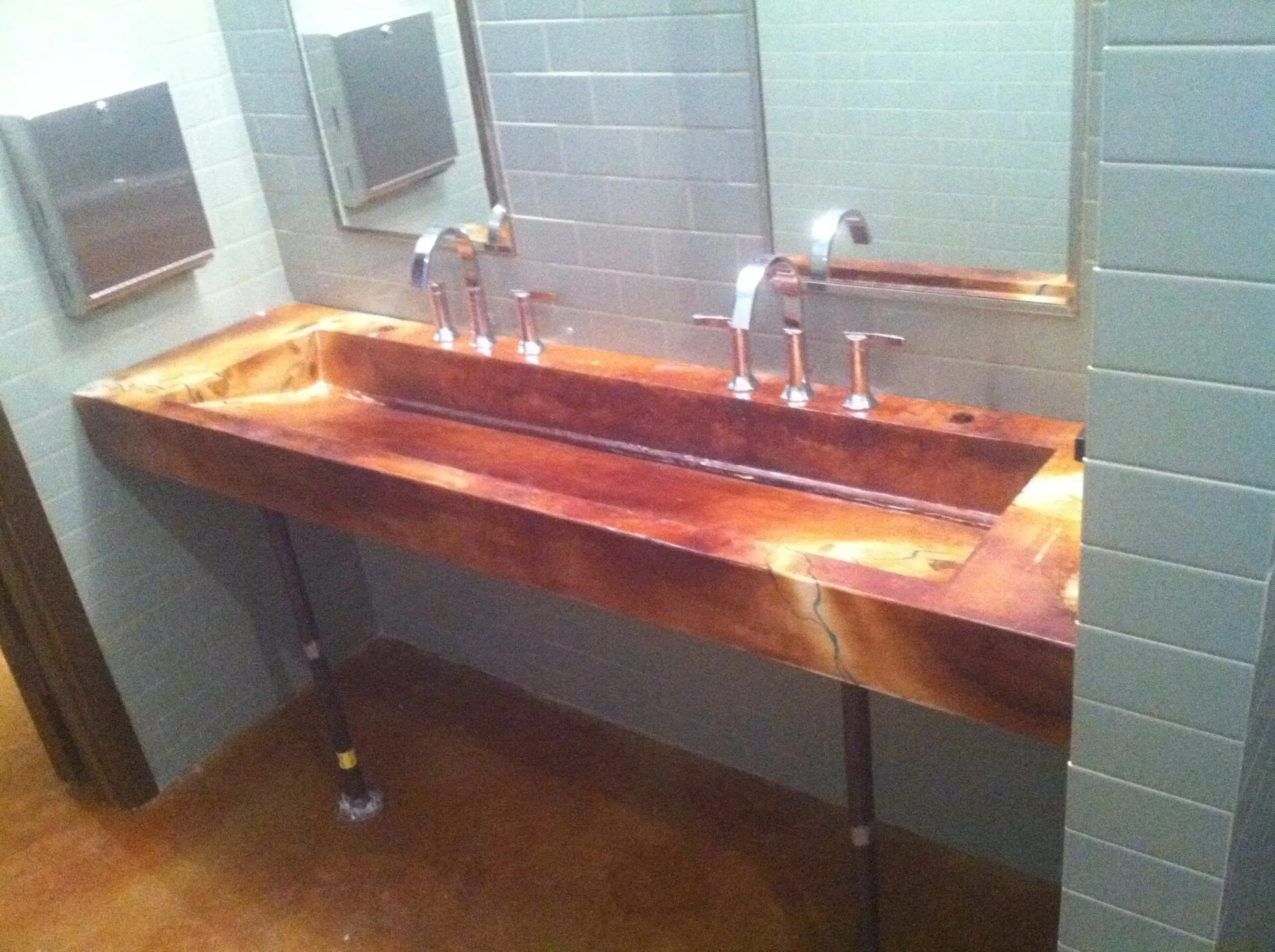 A bathroom with a long sink and a mirror