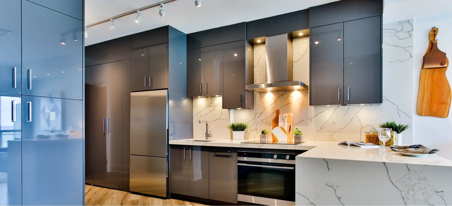 A grey and white kitchen with concrete countertops